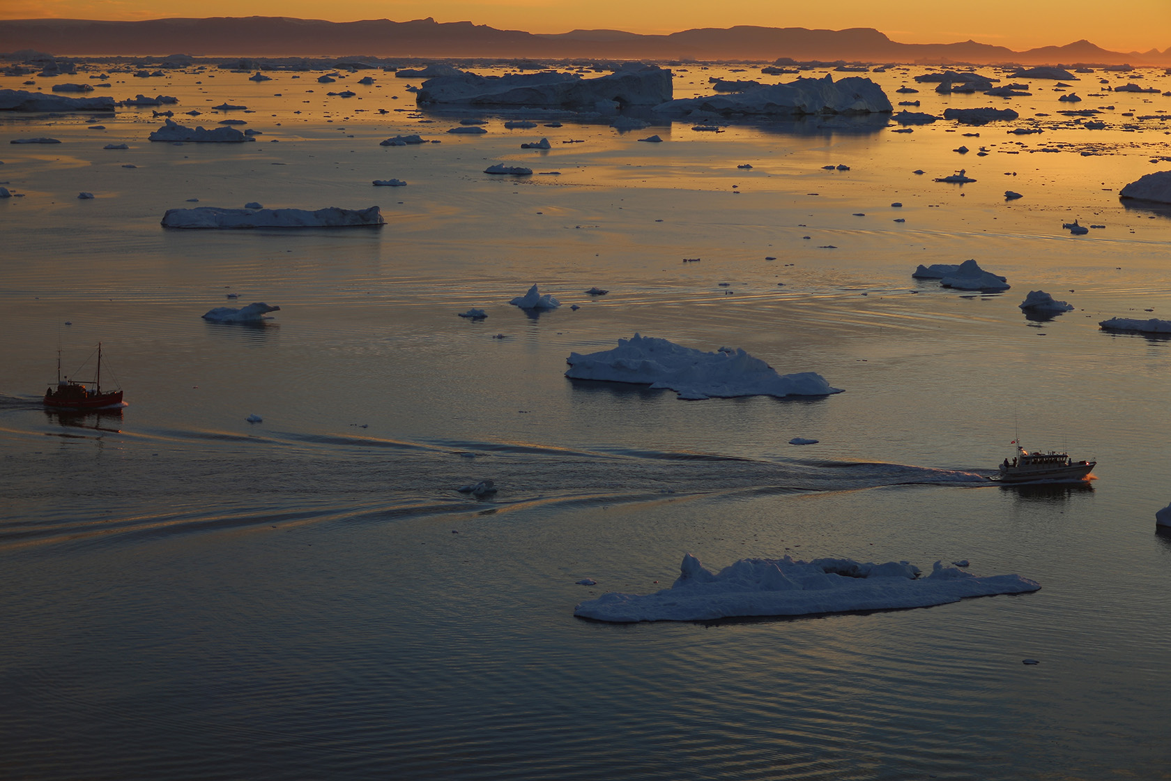 Ships are seen among icebergs that broke off from the Jakobshavn Glacier.